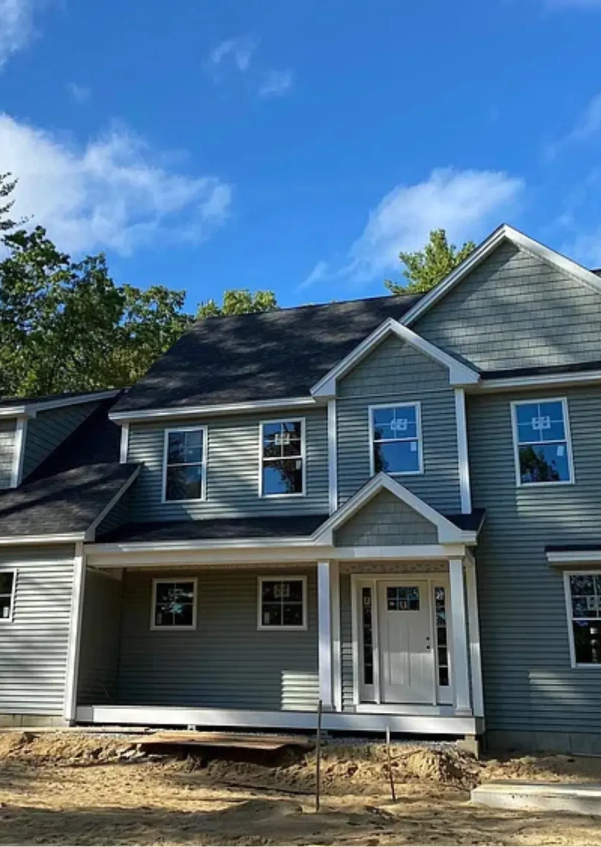 Custom New Hampshire home framed by mature trees